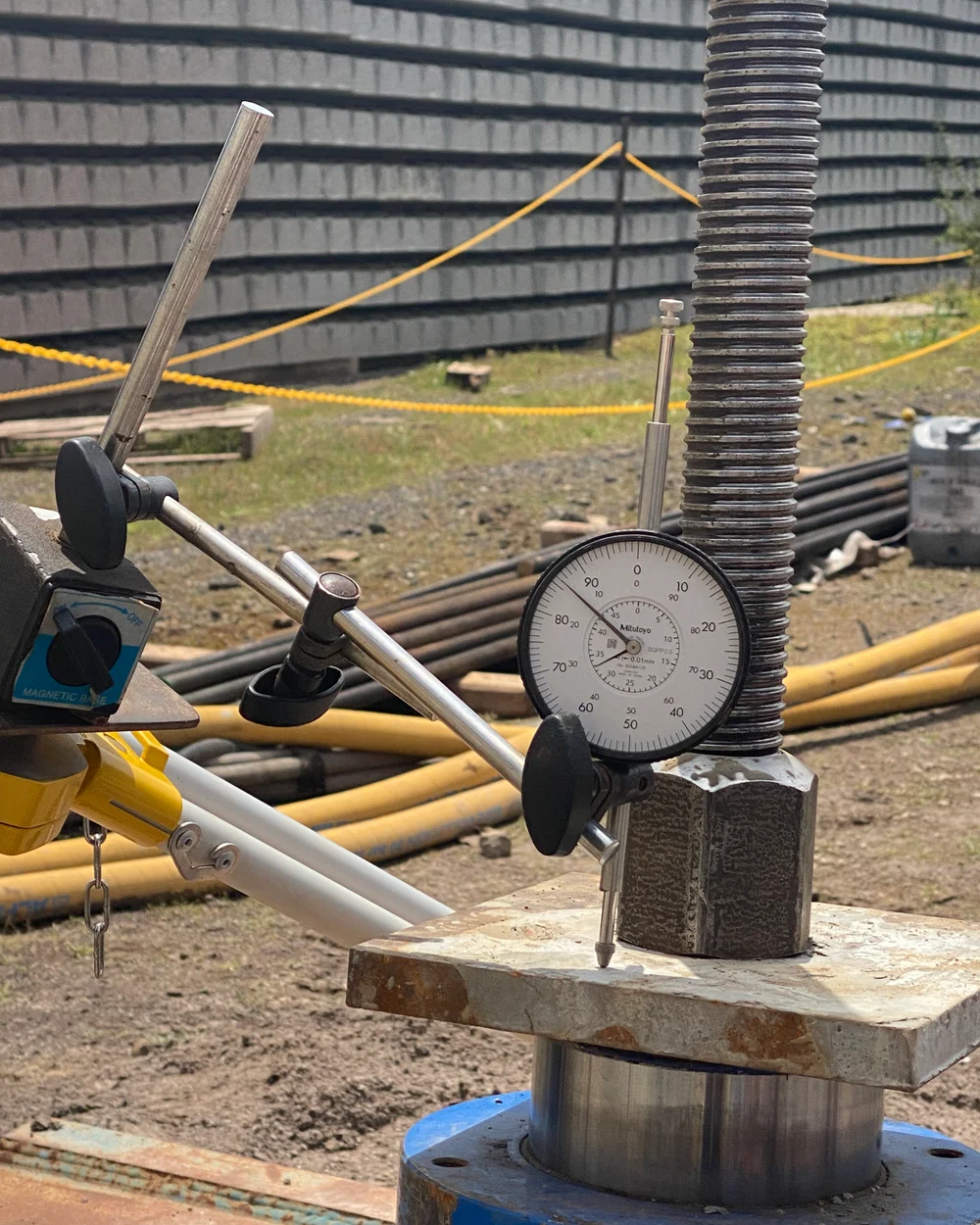Dial gauge and load-testing assembly on a construction site