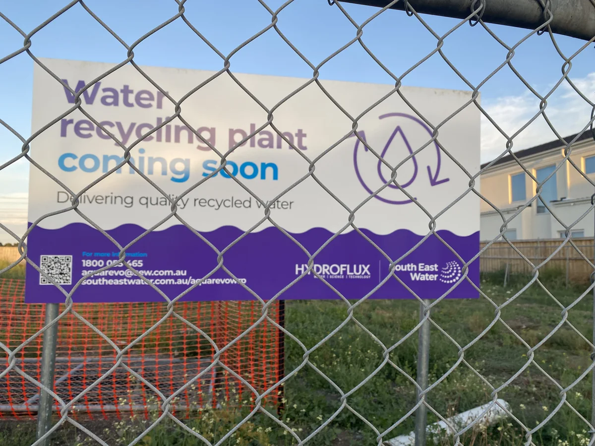 Water recycling plant project sign behind site fencing at Lyndhurst.