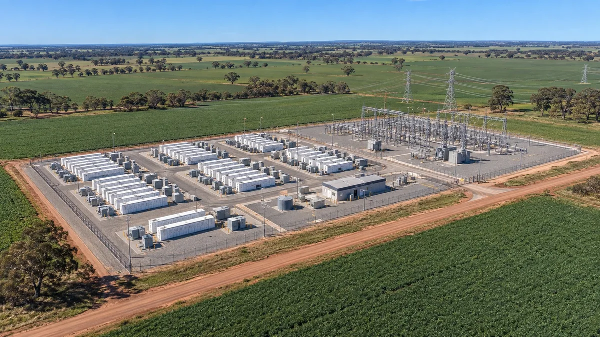 Project illustration showing rows of battery storage units and a substation surrounded by green agricultural fields.